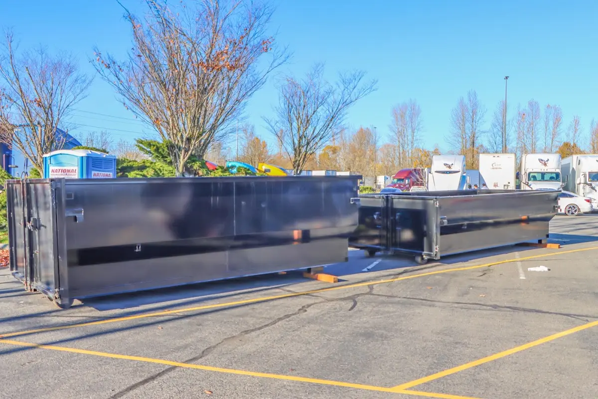 Professional dumpster rental service with roll-off container on residential driveway in Orangetown